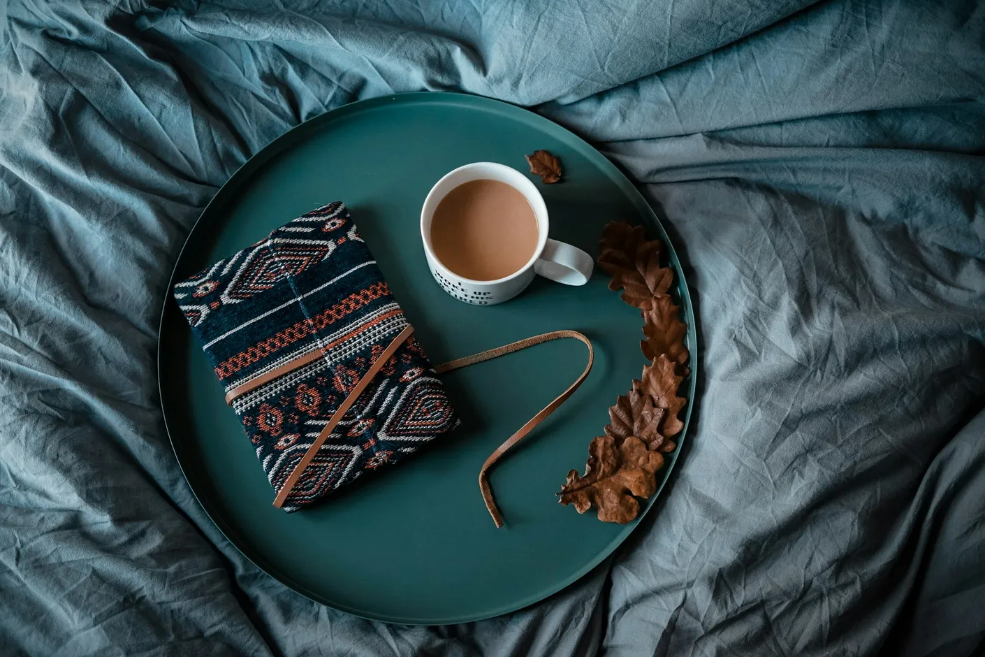 Cup of coffee on a tray with a knitted throw - quiet morning