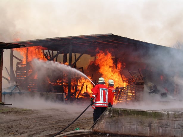 Firefighters with House Putting Water on a Burning House